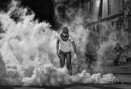 The winning photo chosen by Freedom House showing a Bahraini protestor standing in a cloud of teargas after suppressing a peaceful gathering he had participated in,