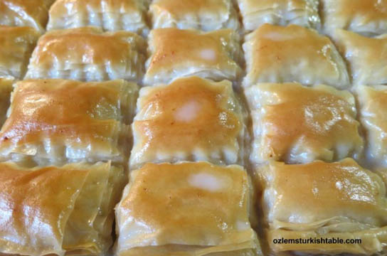 Pour in the luke warm milky syrup over cooled cooked filo pastry and let the pastry to soak the milky syrup for 35- 40 minutes. Pic © Ozlem Warren